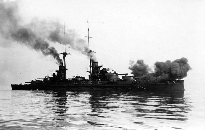 Conte di Cavour fires a salvo from her forward guns.jpg
