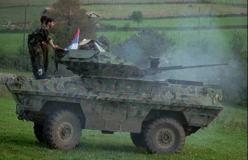 Serbs shooting at something in the outskirts of the city